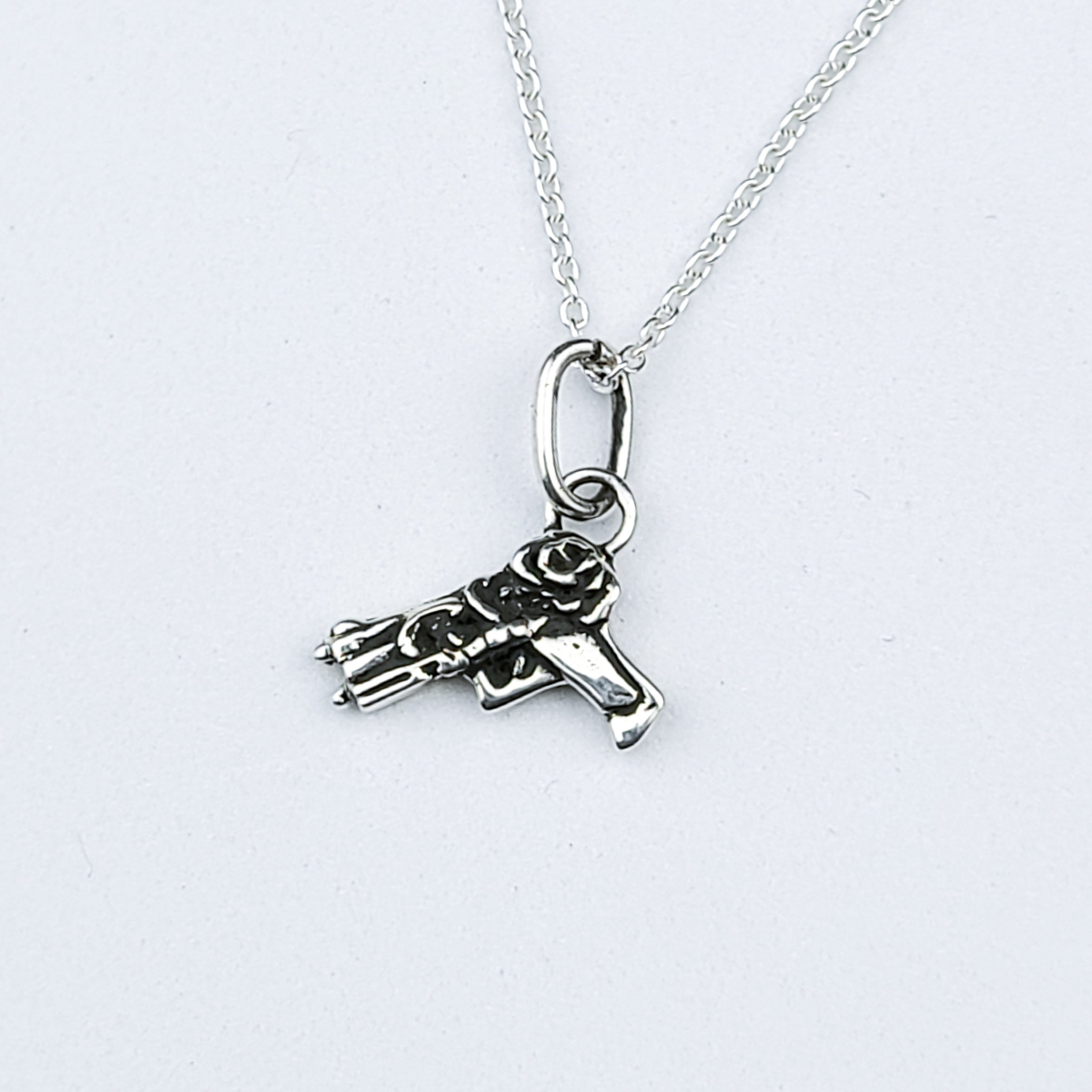 Tiny Silver Gun with Roses Pendant