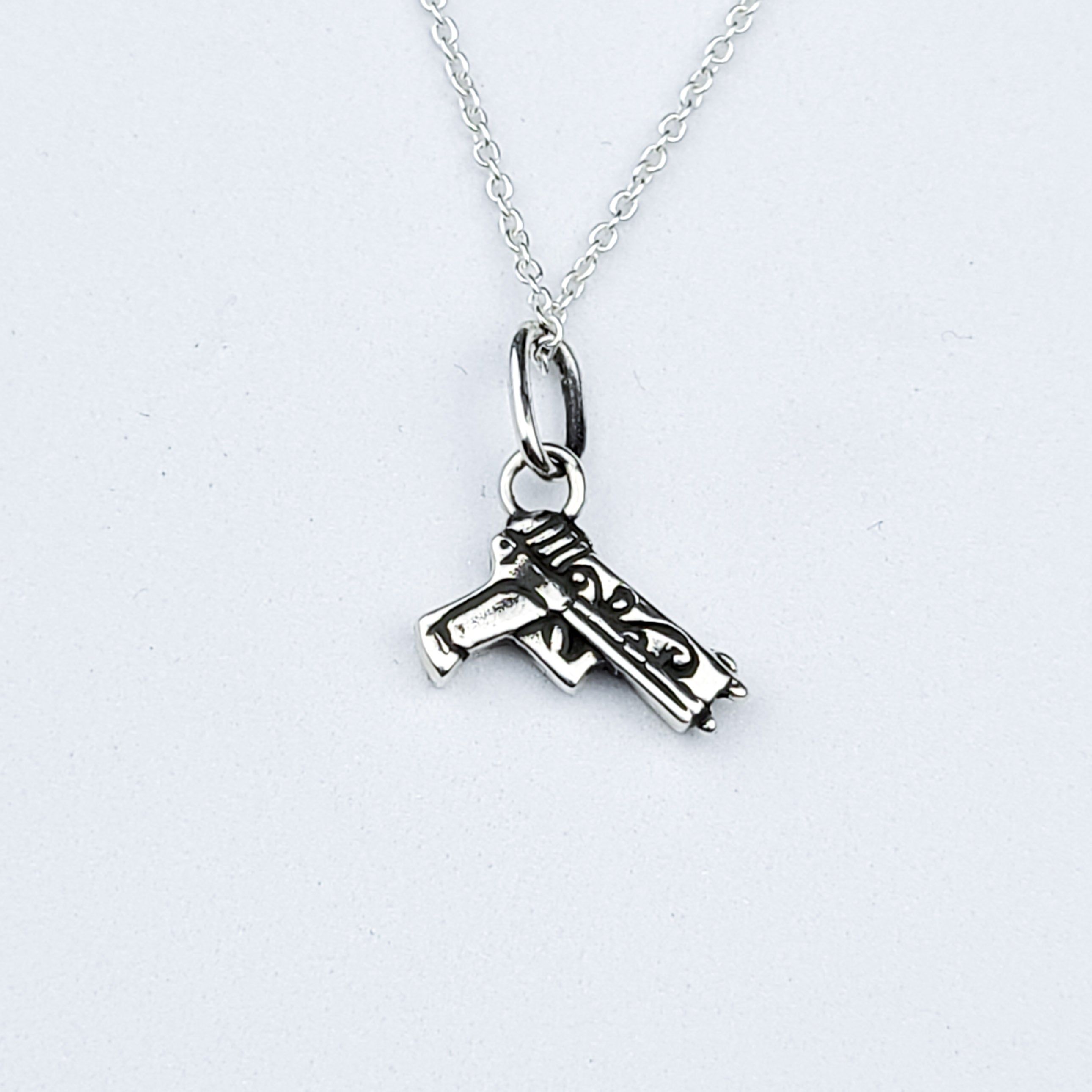 Tiny Silver Gun with Roses Pendant